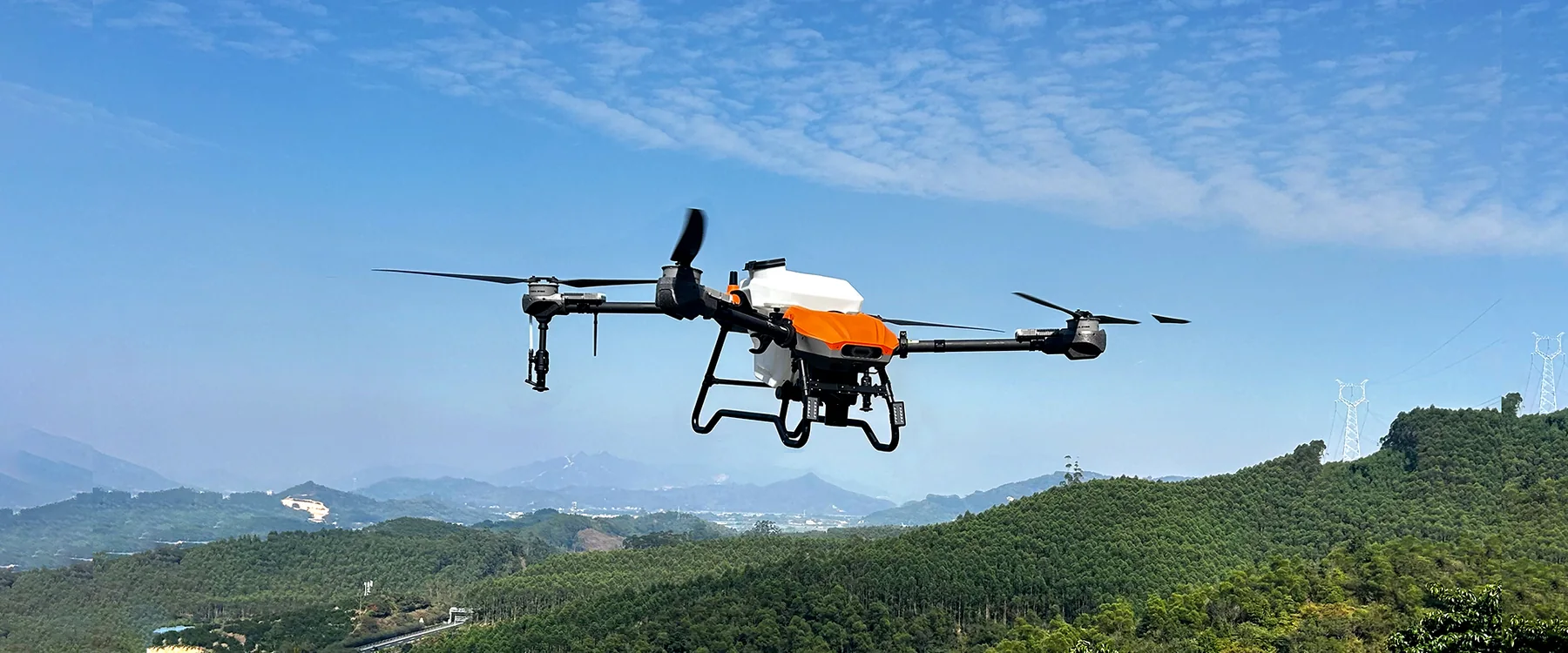 HD580 drone in flight over mountain farmland